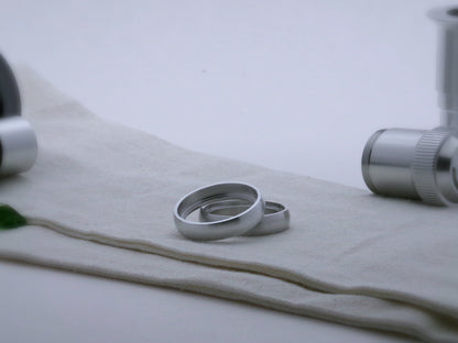 Pair of rounded profile aluminum accent rings for VHC lightsabers, one askew upon the other, showing shimsert.