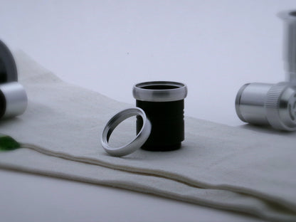 A pair of rounded profile aluminum accent rings for VHC lightsabers, the first installed on a black grip extension, the second leaning against it.