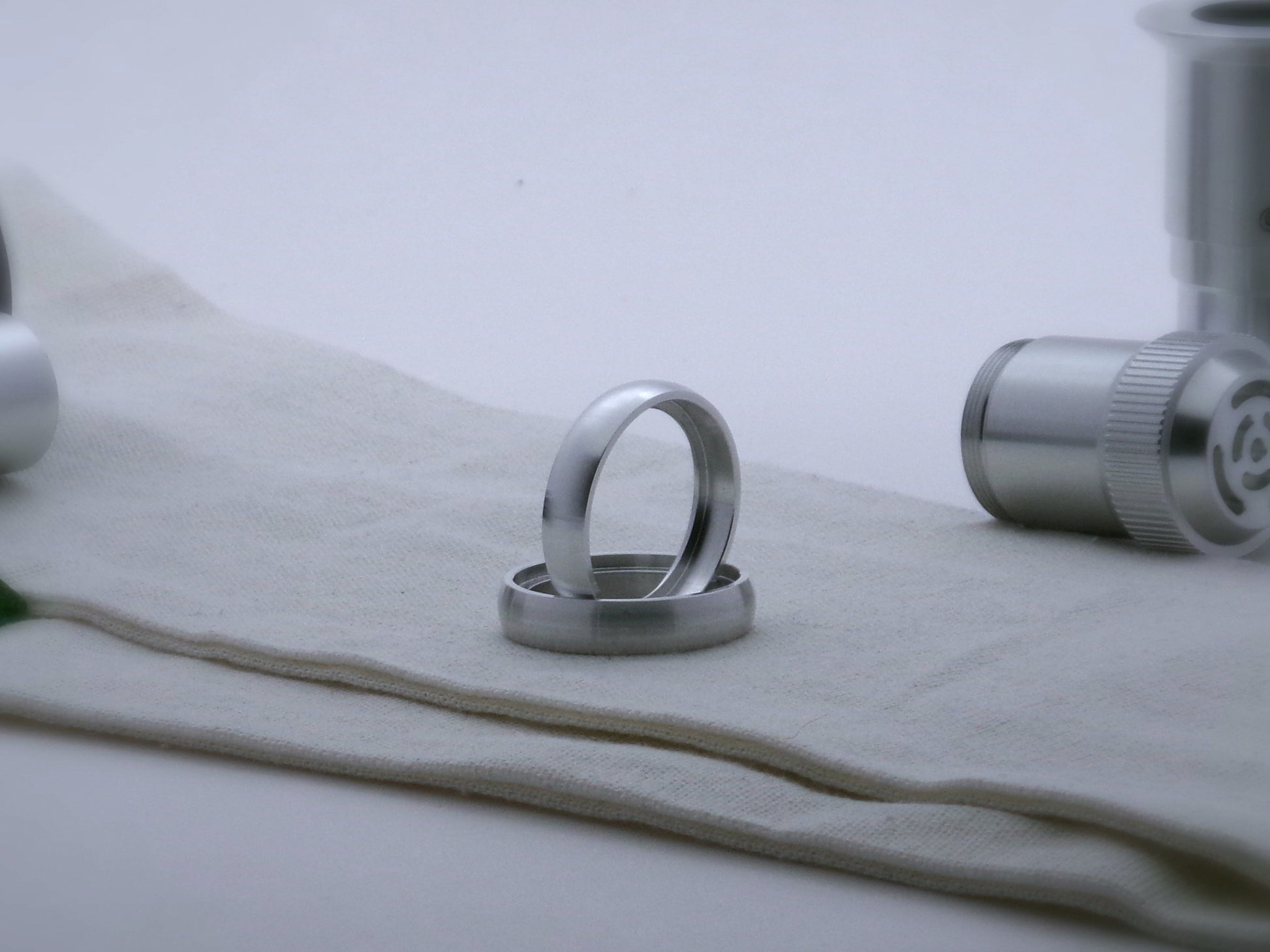 Pair of rounded profile accent rings for VHC lightsabers, one standing vertically on edge inside the other.