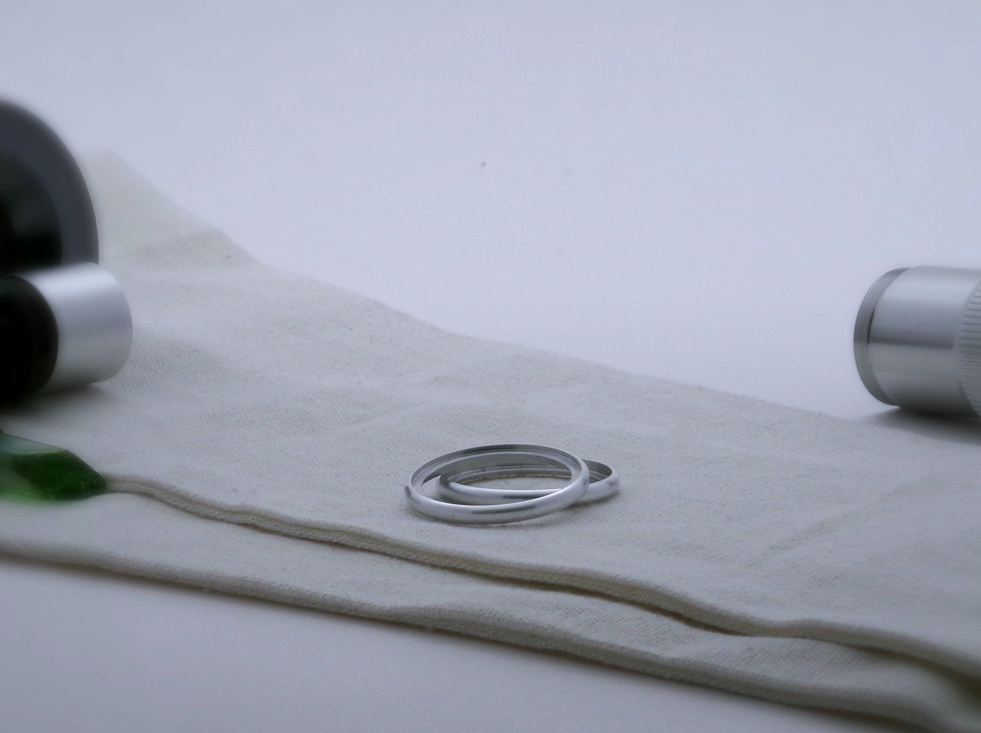 Pair of round profile aluminum accent rings for VHC lightsabers, one askew upon the other, showing shimsert.