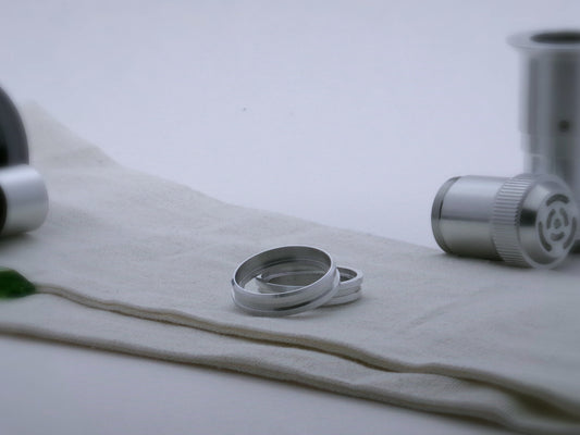 Pair of aluminum accent rings for VHC lightsabers with offset bands and a deep central groove, one askew upon the other, showing shimsert.