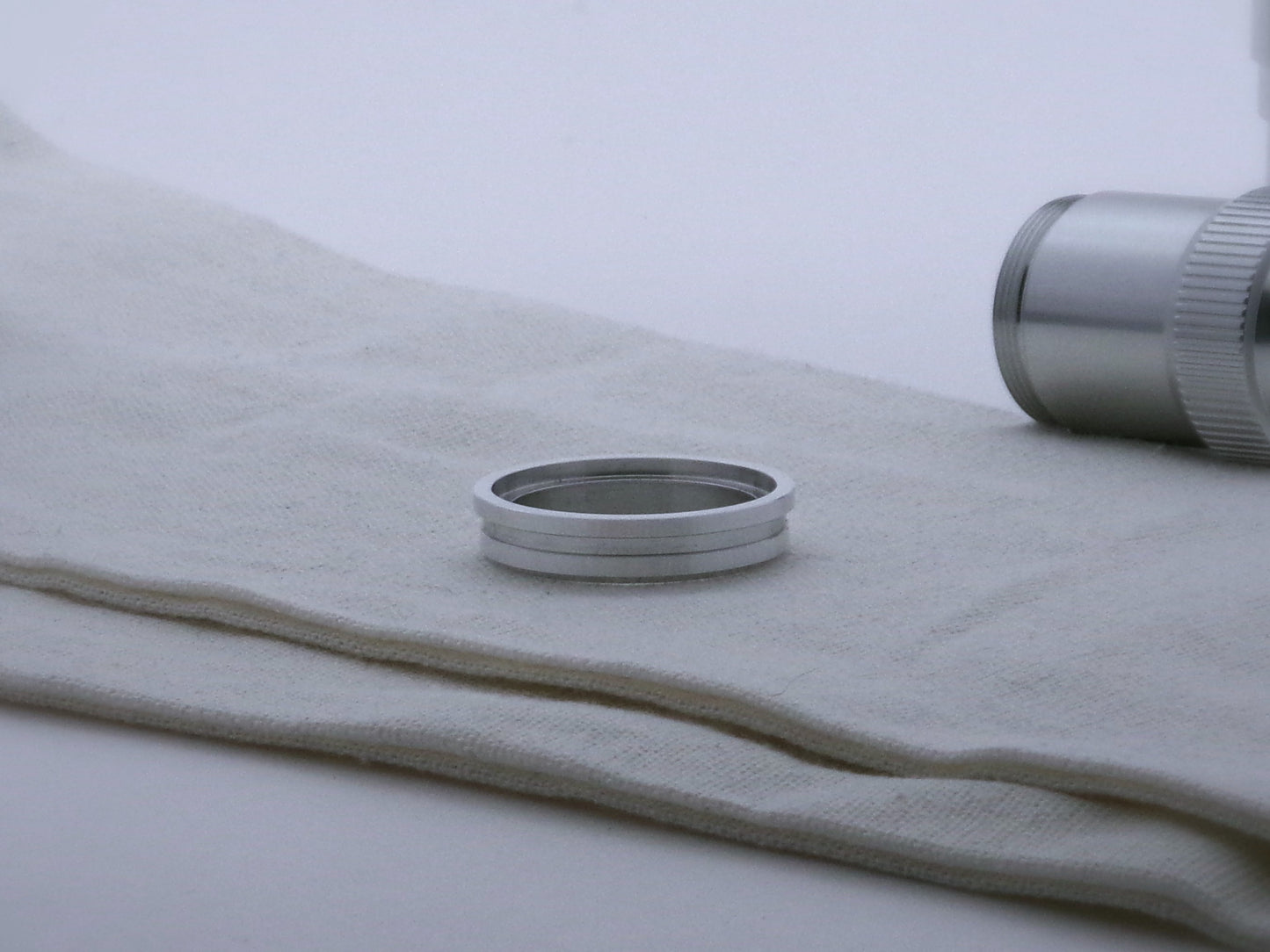 Single aluminum accent ring for VHC lightsabers with offset bands and a deep central groove, shimsert facing upward.