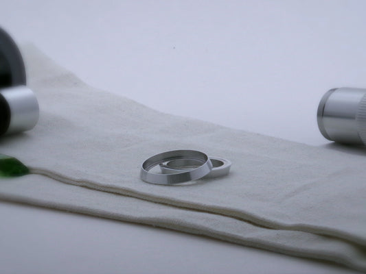 Pair of bevelled aluminum accent rings for VHC lightsabers, one askew upon the other, showing shimsert.