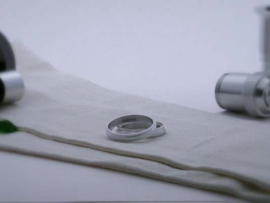 Pair of aluminum accent rings for VHC lightsabers with a proud central rib, one askew upon the other, showing shimsert.