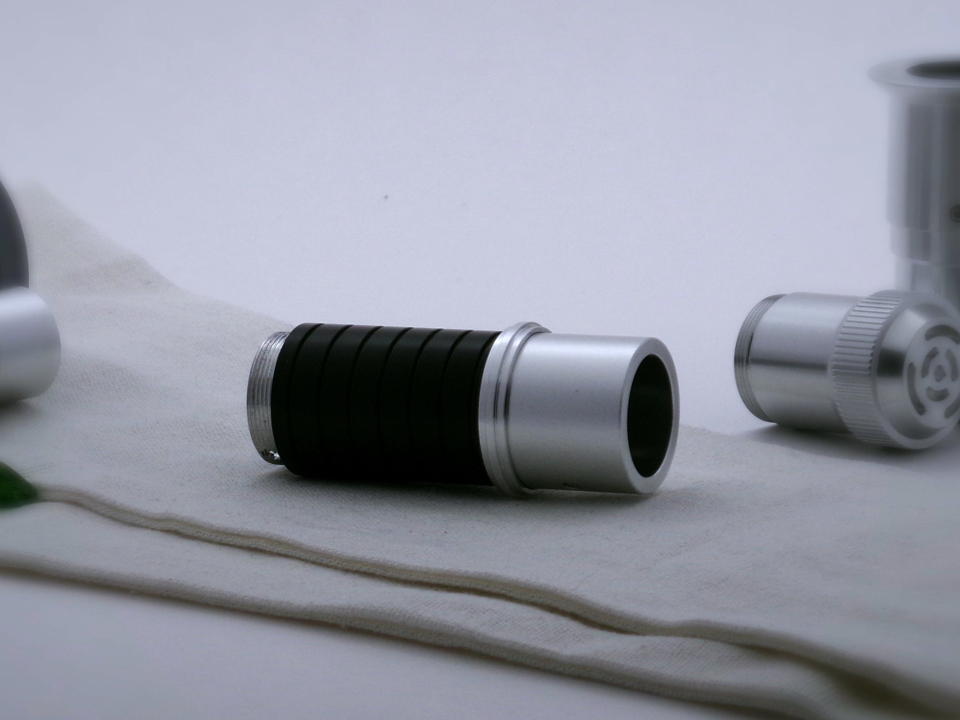 Single, aluminum accent ring with a proud central rib installed on a mixed VHC lightsaber component part.