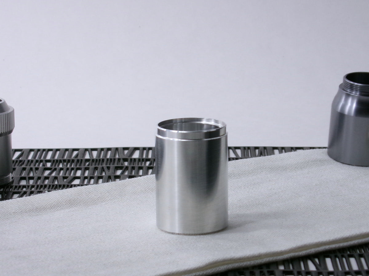 A stepped, VHC-compatible, lightsaber Accent Sleeve sits vertical on a cloth.