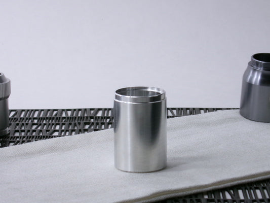 A stepped, VHC-compatible, lightsaber Accent Sleeve sits vertical on a cloth.