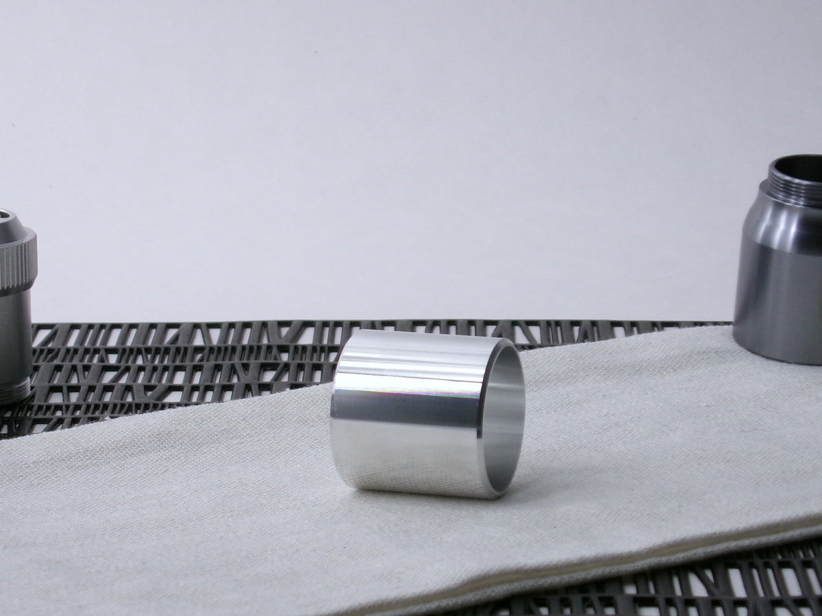 A beveled, VHC-compatible lightsaber Accent Sleeve sits 3/4 view showing interior-view on a cloth.