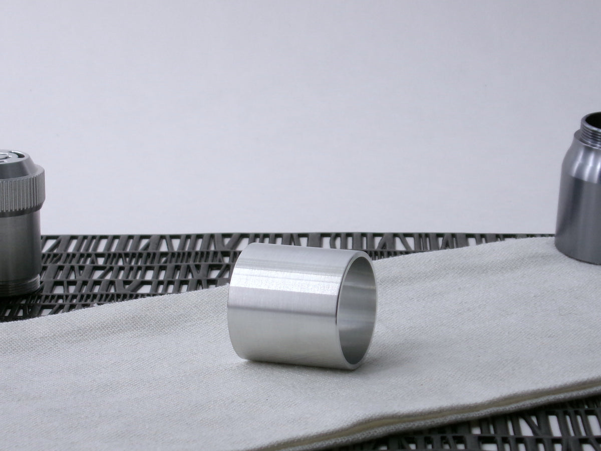 A plain, VHC-compatible, lightsaber Accent Sleeve sits 3/4 view showing interior, on a cloth.