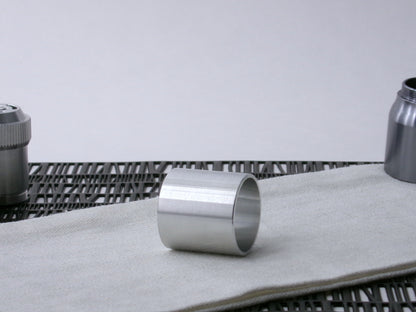 A plain, VHC-compatible, lightsaber Accent Sleeve sits 3/4 view showing interior, on a cloth.