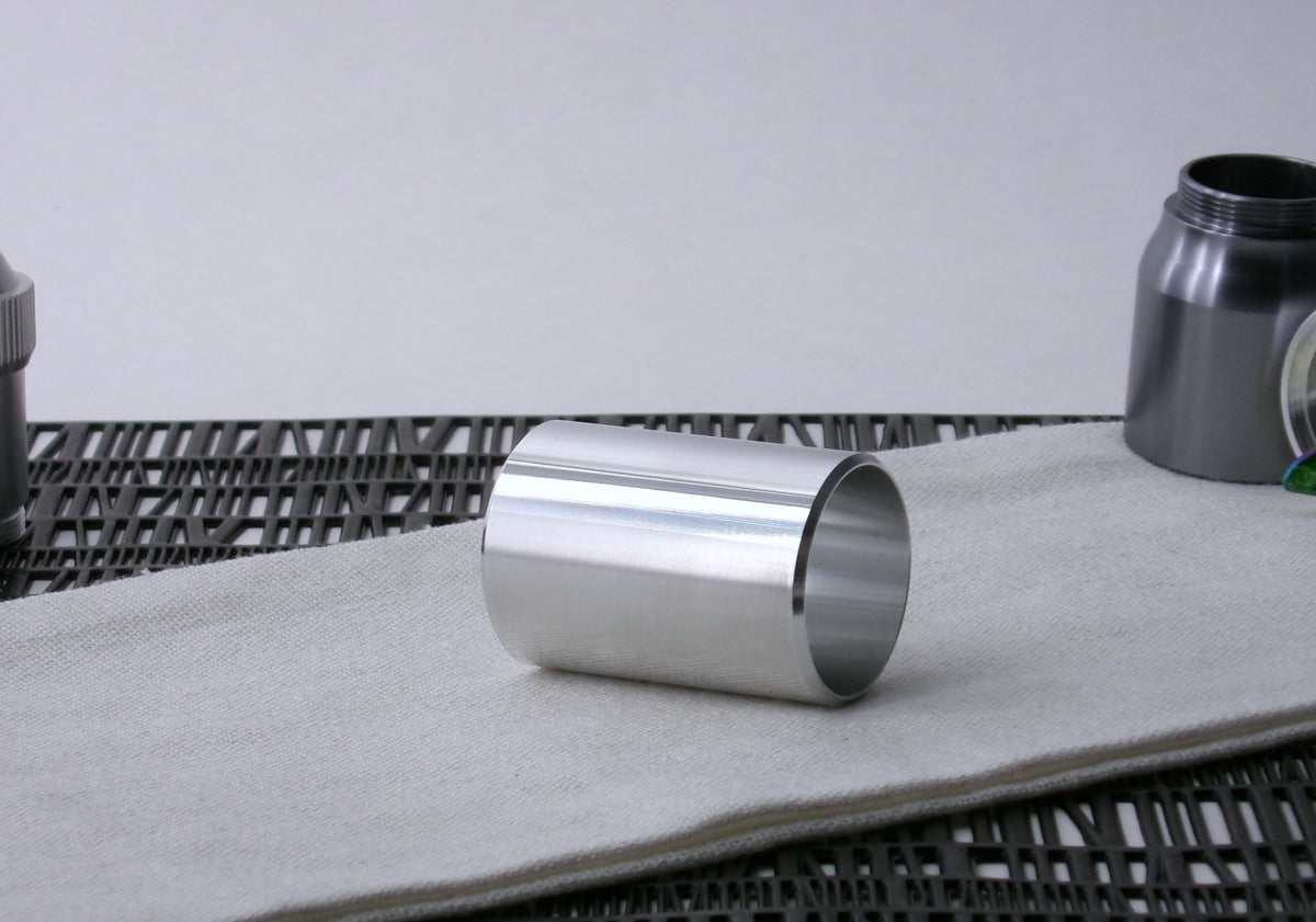 A beveled , VHC-compatible, lightsaber Accent Sleeve sits 3/4 view showing interior, on a cloth.