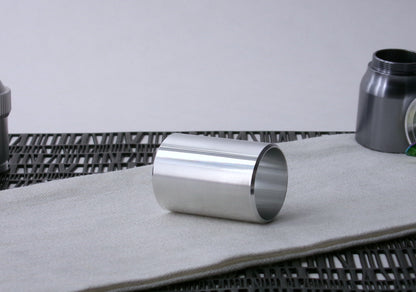 A beveled , VHC-compatible, lightsaber Accent Sleeve sits 3/4 view showing interior, on a cloth.