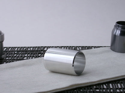 A stepped, VHC-compatible, lighsaber Accent Sleeve sits 3/4 view showing interior-view on a cloth.