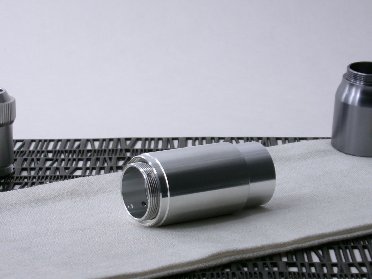 A stepped, VHC-compatible, lightsaber Accent Sleeve sits 3/4 view installed on a CSF Body Segment.