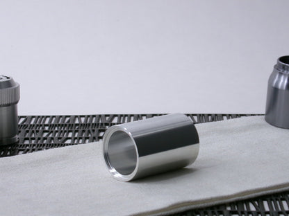 A simple, VHC-compatible, lightsaber Accent Sleeve sits 3/4 view showing shim-sert, on a cloth.