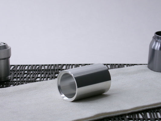 A simple, VHC-compatible, lightsaber Accent Sleeve sits 3/4 view showing shim-sert, on a cloth.