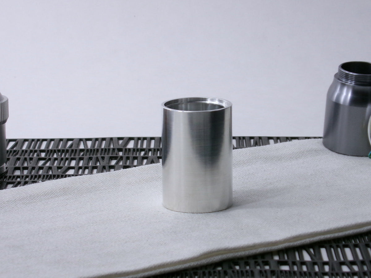 A simple, VHC-compatible lightsaber Accent Sleeve sits vertical on a cloth.