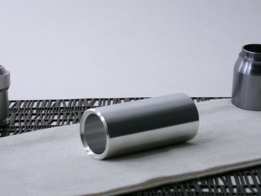 A beveled, VHC-compatible, lightsaber Accent Sleeve sits 3/4 view showing shim-sert, on a cloth.