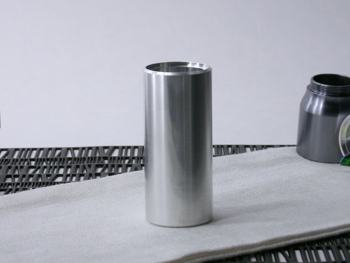 A beveled, VHC-compatible lightsaber Accent Sleeve sits vertical on a cloth.