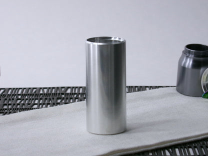 A beveled, VHC-compatible lightsaber Accent Sleeve sits vertical on a cloth.