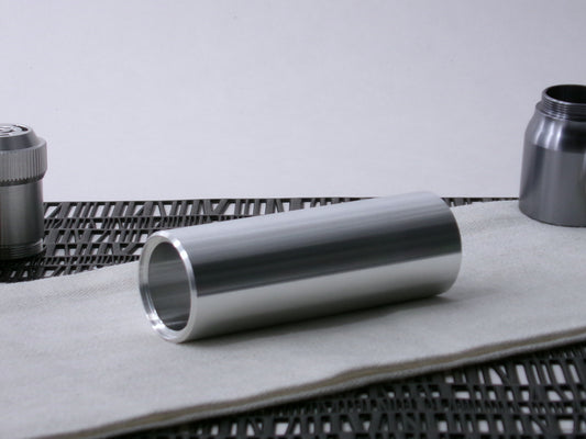 A beveled, VHC-compatible, lightsaber Accent Sleeve sits 3/4 view showing shim-sert, on a cloth.