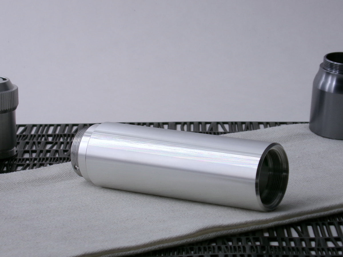 A beveled, VHC-compatible, lightsaber Accent Sleeve sits 3/4 view installed on a CSF Body Segment.