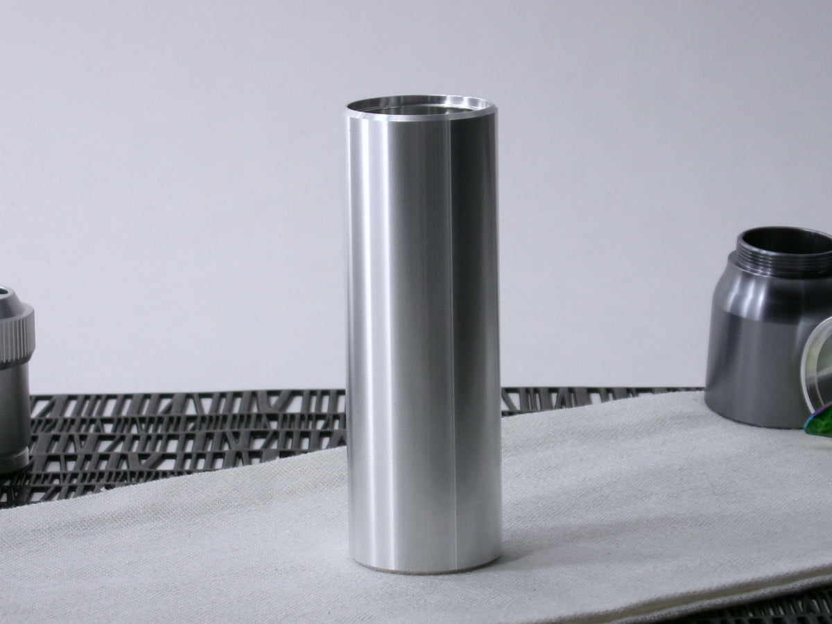A simple, VHC-compatible lightsaber Accent Sleeve sits vertical on a cloth.