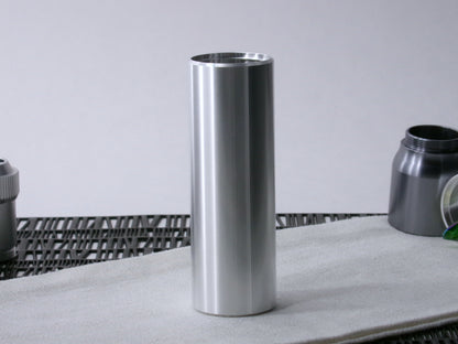 A simple, VHC-compatible lightsaber Accent Sleeve sits vertical on a cloth.