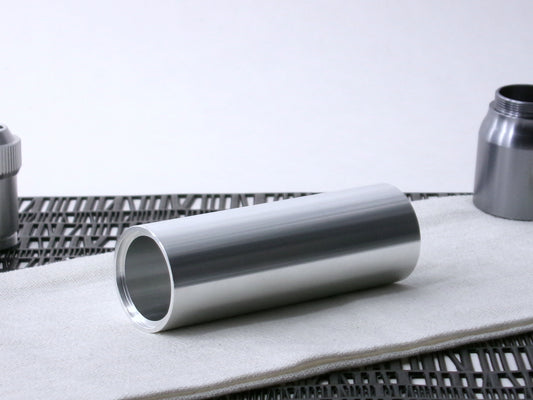 A simple, VHC-compatible, lightsaber Accent Sleeve sits 3/4 view showing shim-sert, on a cloth.