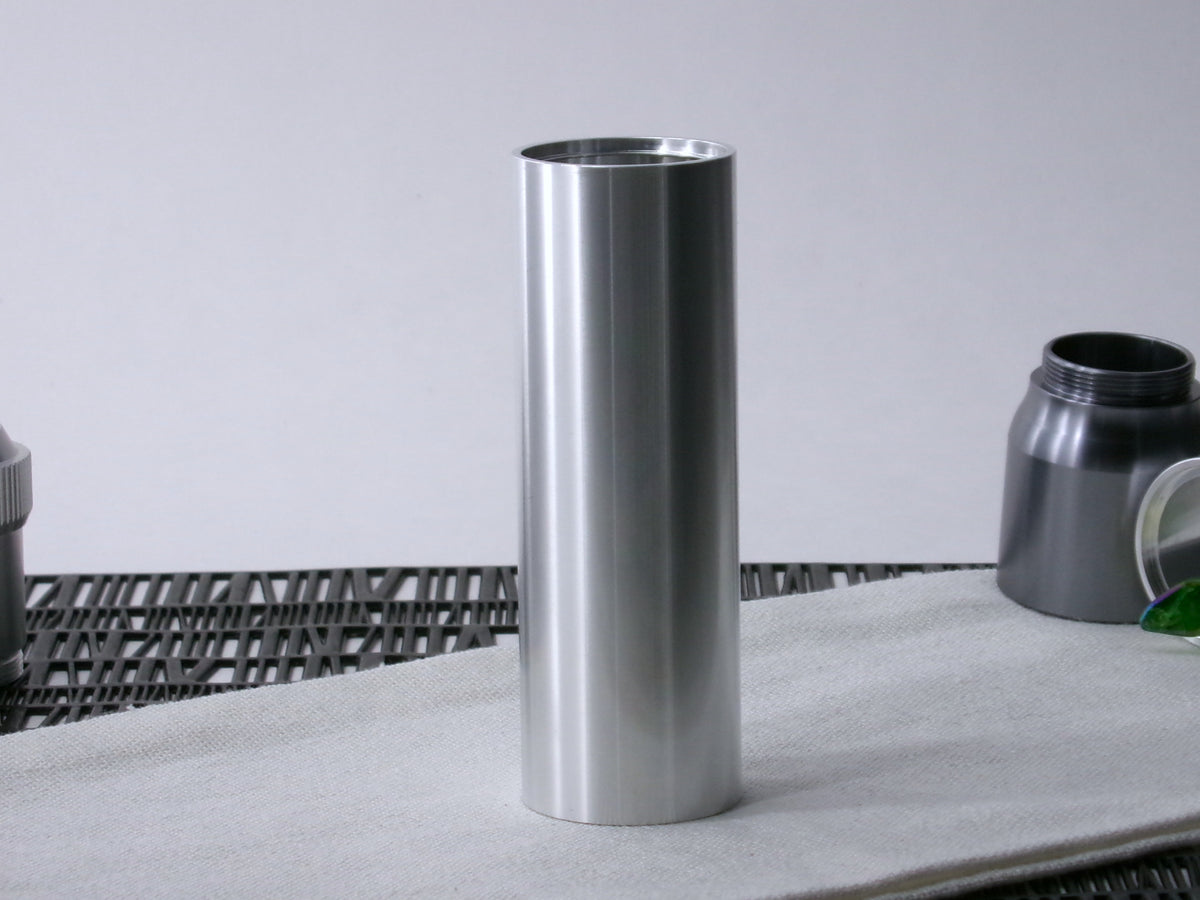 A simple, VHC-compatible lightsaber Accent Sleeve sits vertical on a cloth.