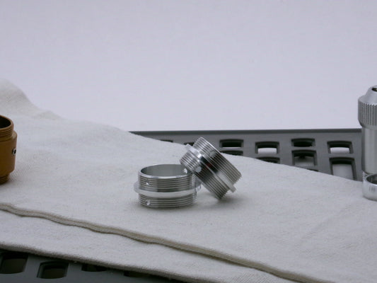 Pair of aluminum male/male threaded adapter for VHC lightsabers set askew; 33mm diameter.