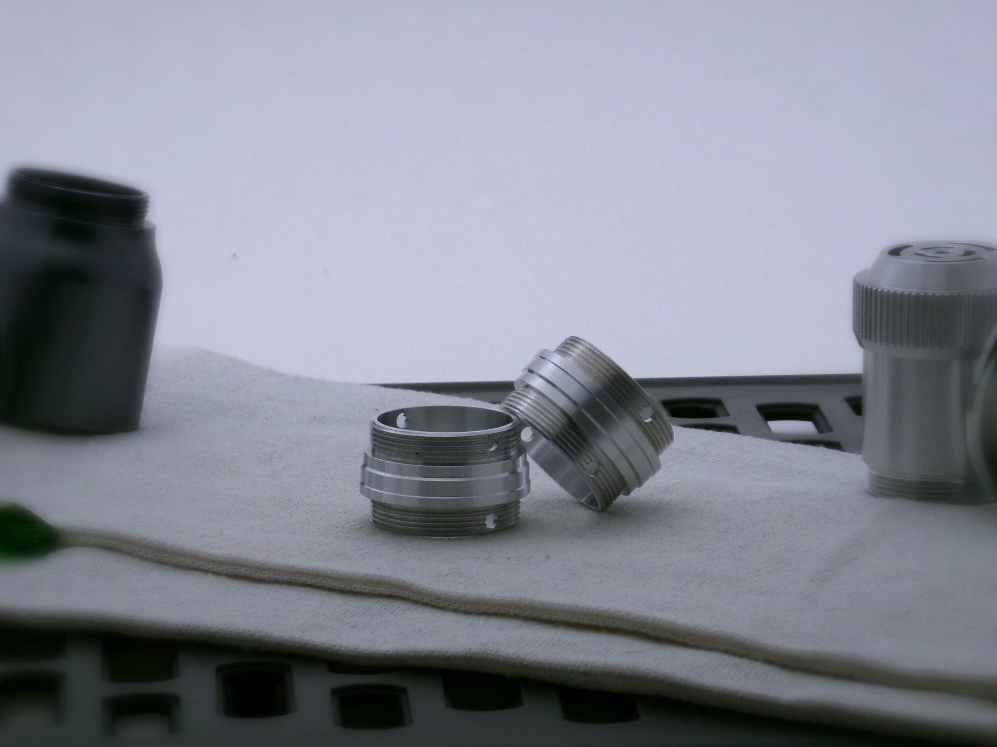 Pair of aluminum male/male threaded stepped adapters for VHC lightsabers set askew.
