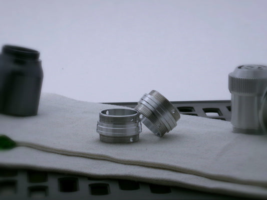 Pair of aluminum male/male threaded stepped adapters for VHC lightsabers set askew.
