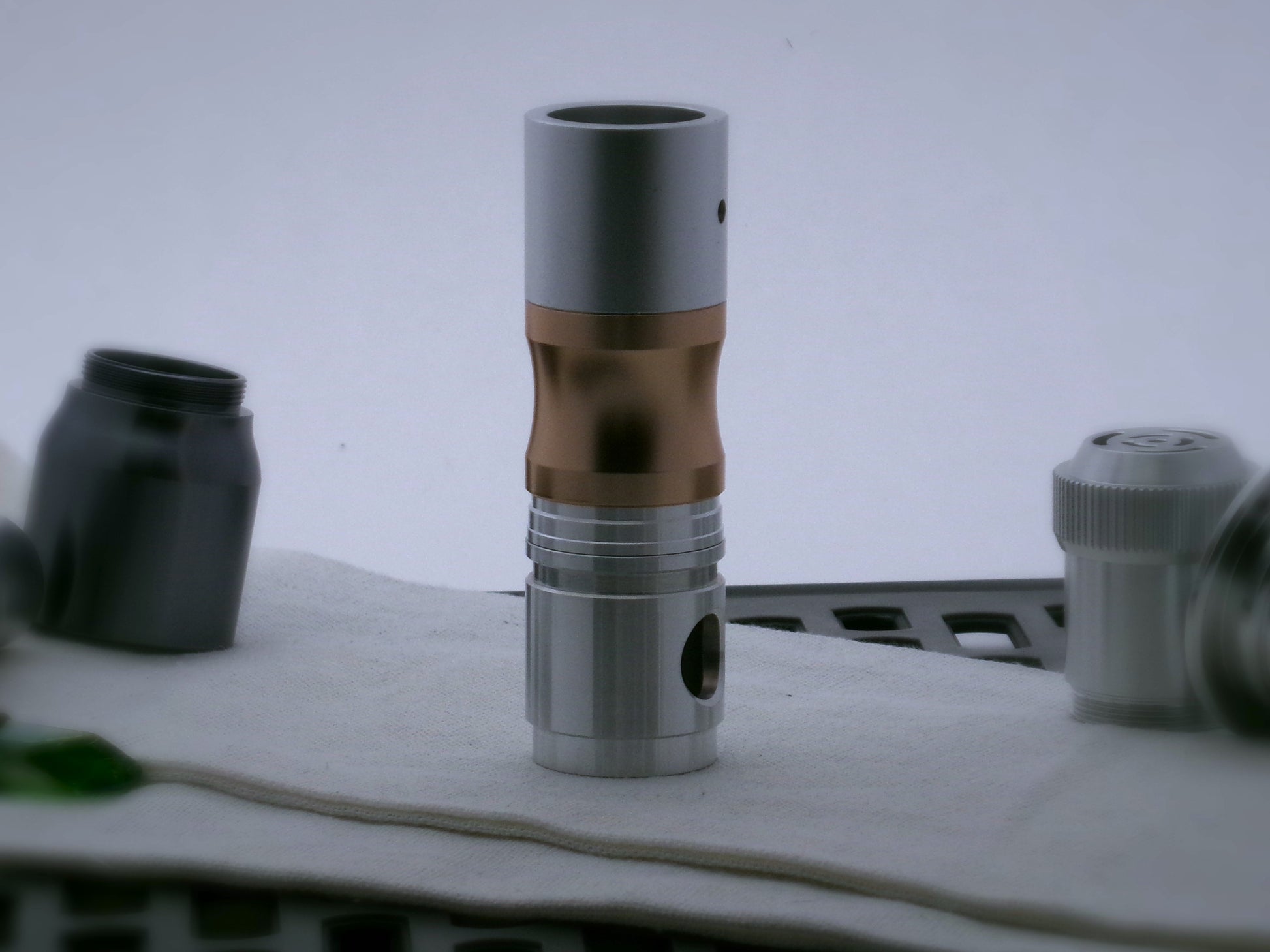 Single aluminum male/male threaded stepped adapter installed between a CSF Switch-Type_2.1 and various VHC lightsaber components.