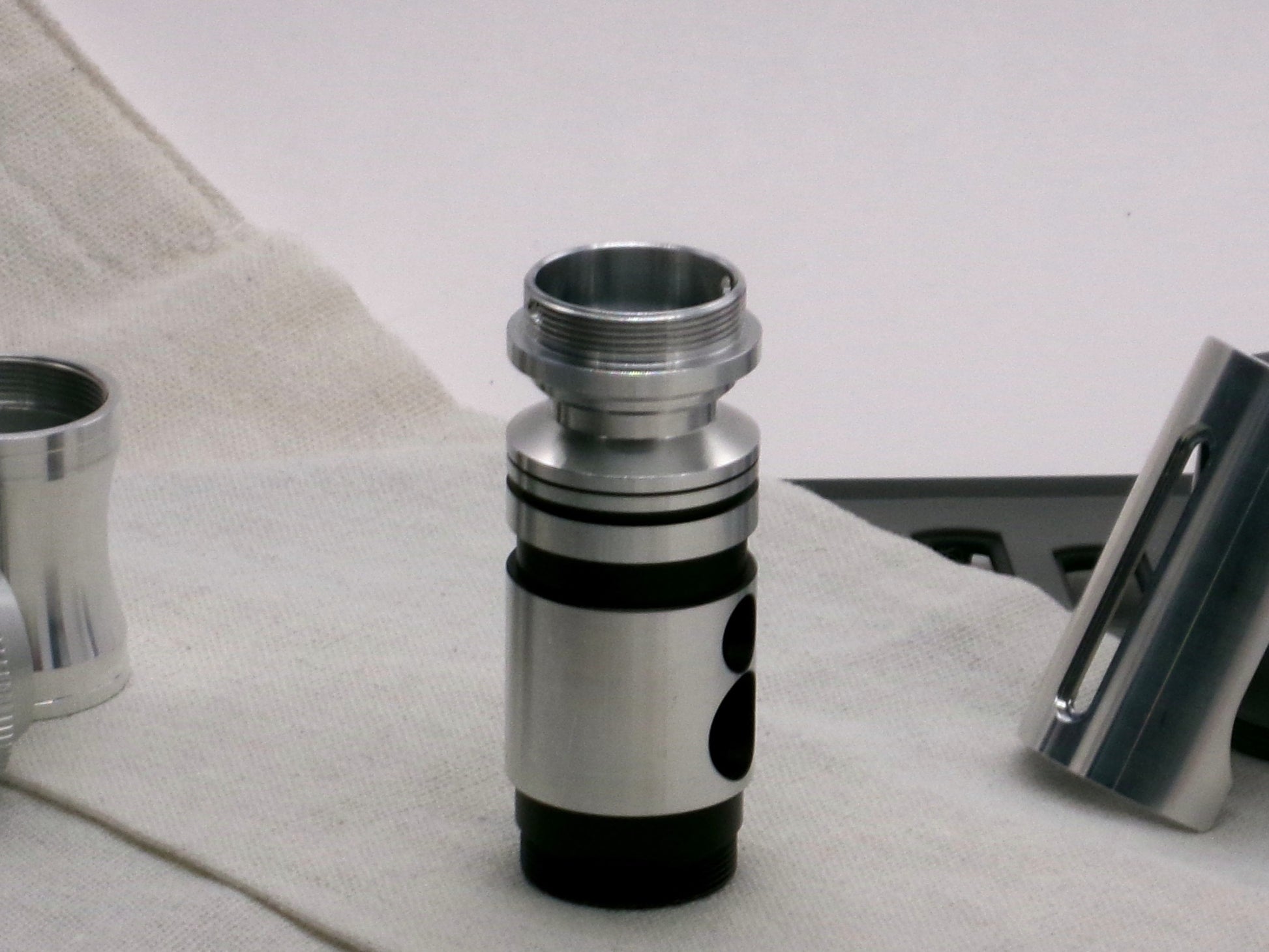 A versatile, aluminum male-to-male hybrid adapter compatible with VHC lightsabers, installed on a VHC switch, standing proud.