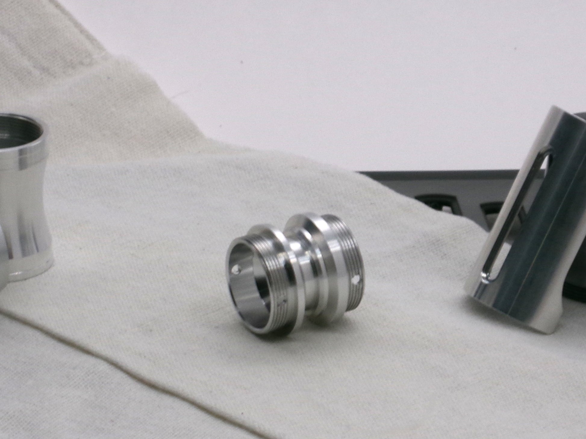 A versatile, aluminum male-to-male hybrid adapter compatible with VHC lightsabers, 3/4 view.