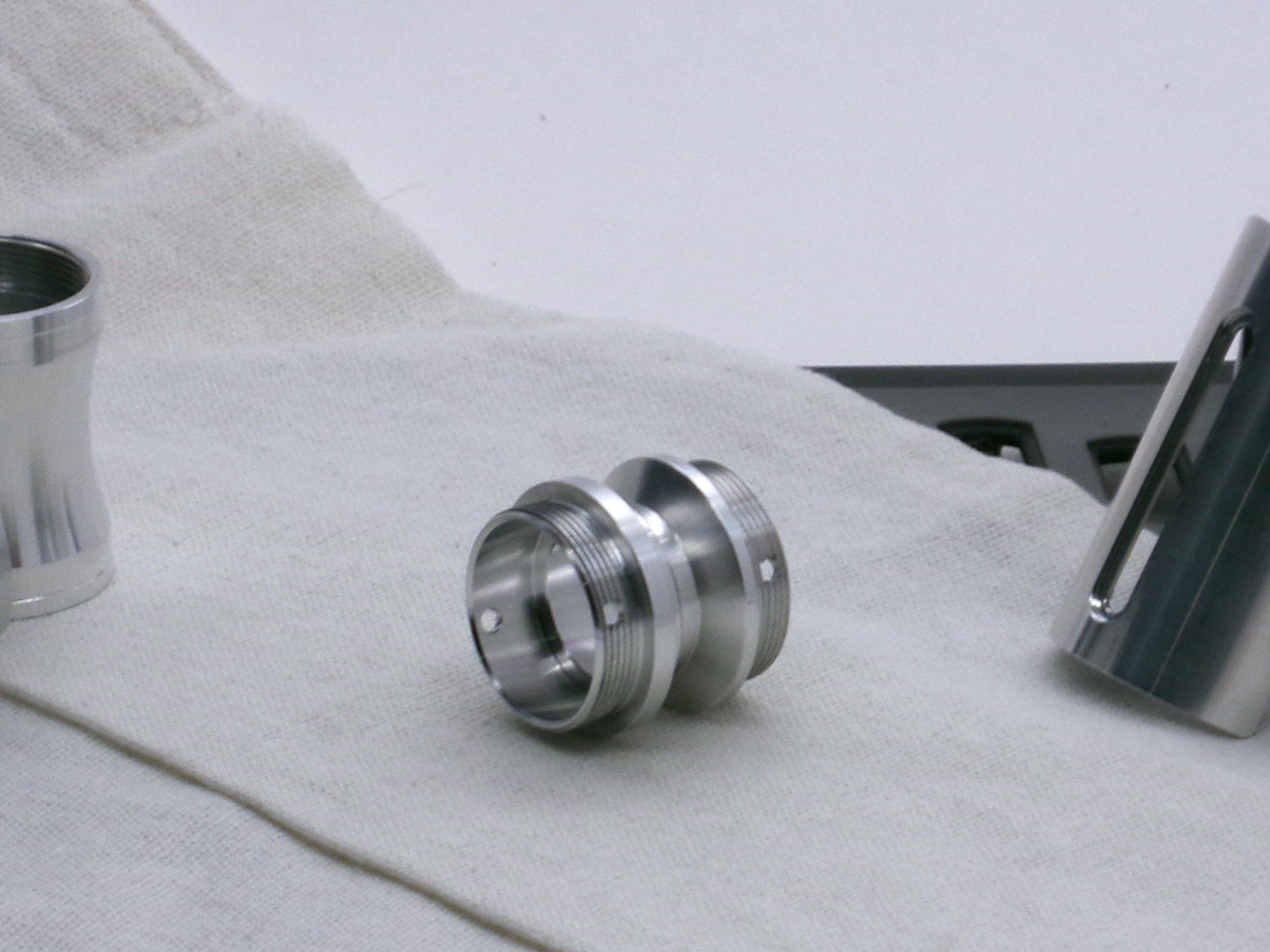 A versatile, aluminum male-to-male hybrid adapter compatible with VHC lightsabers, 3/4 view.