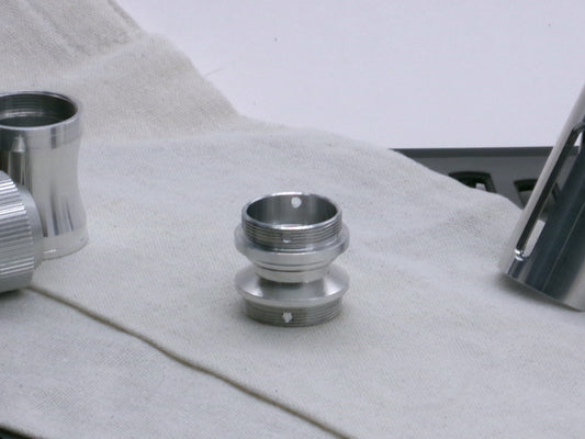 A versatile, aluminum male-to-male hybrid adapter compatible with VHC lightsabers, standing tall.