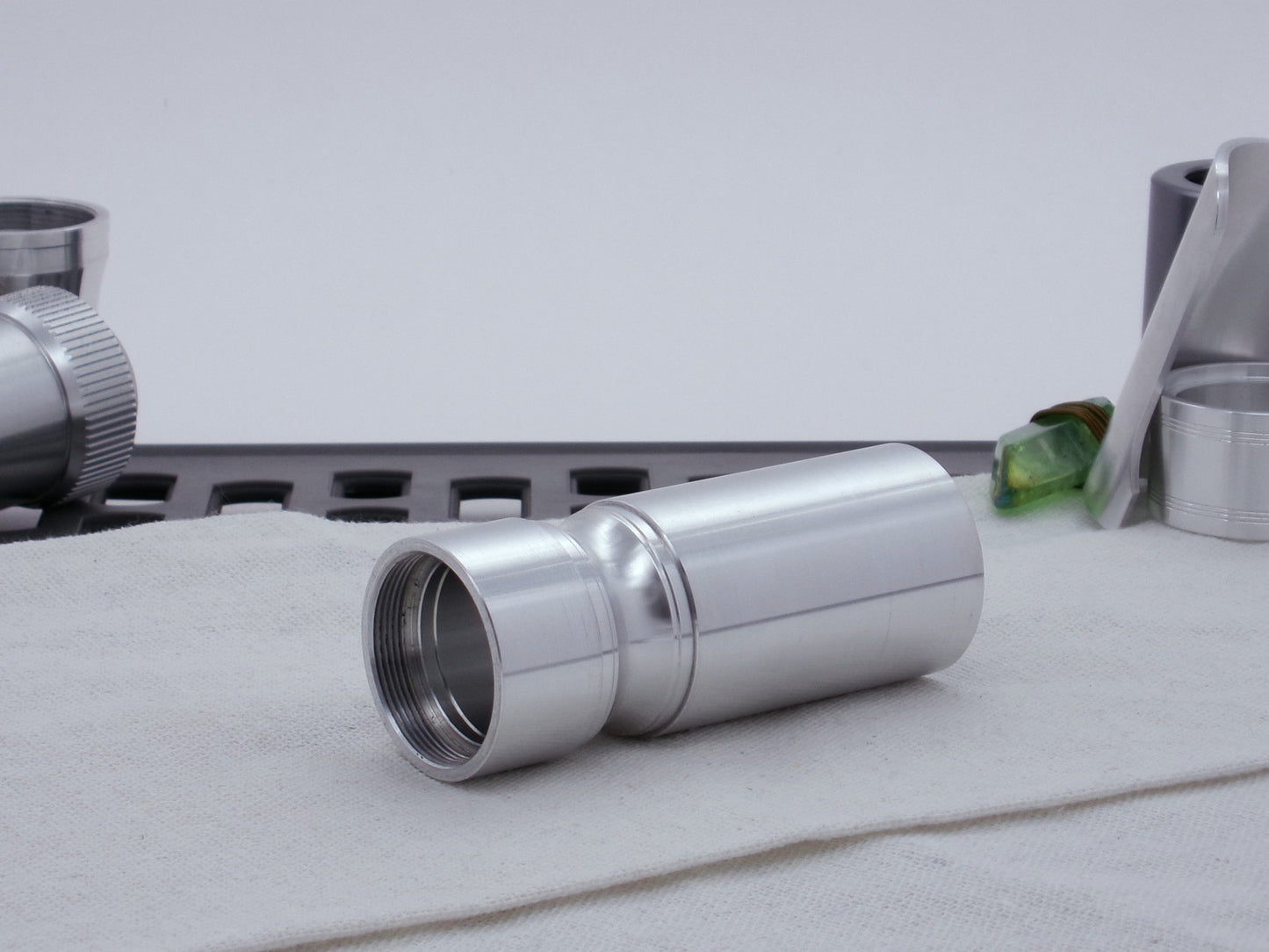 Male threaded, round choke adapter for VHC lightsabers installed between two Body Components.