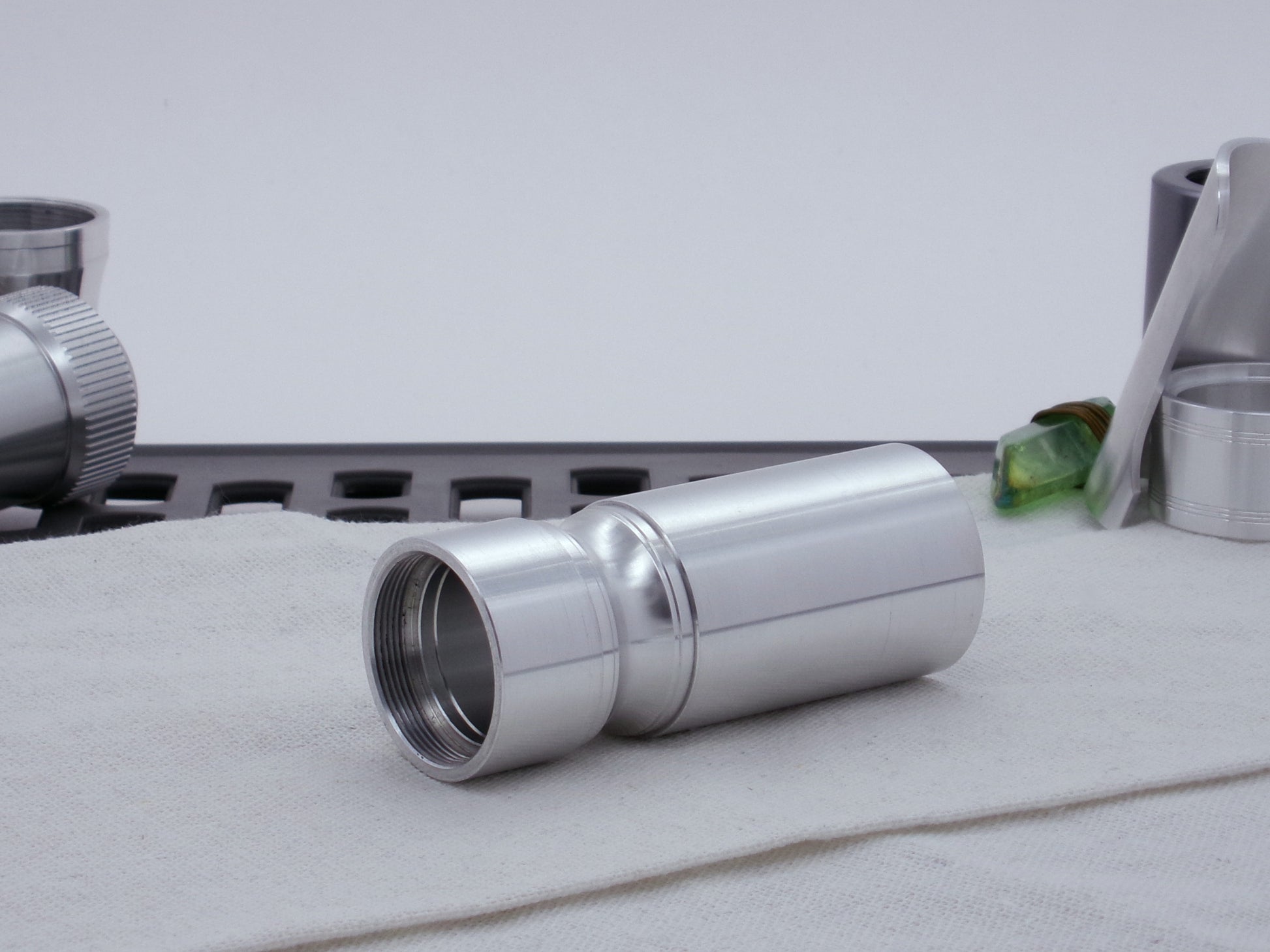 Male threaded, round choke adapter for VHC lightsabers installed between two Body Components.