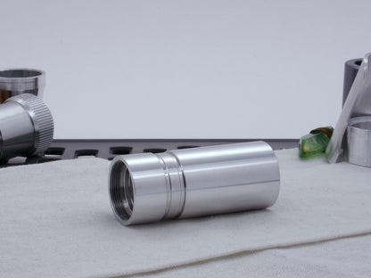 Ki Adi Mundi styled, stepped male adapter for VHC lightsabers, installed between two body components, resting on cloth, three-quarter view angled left.