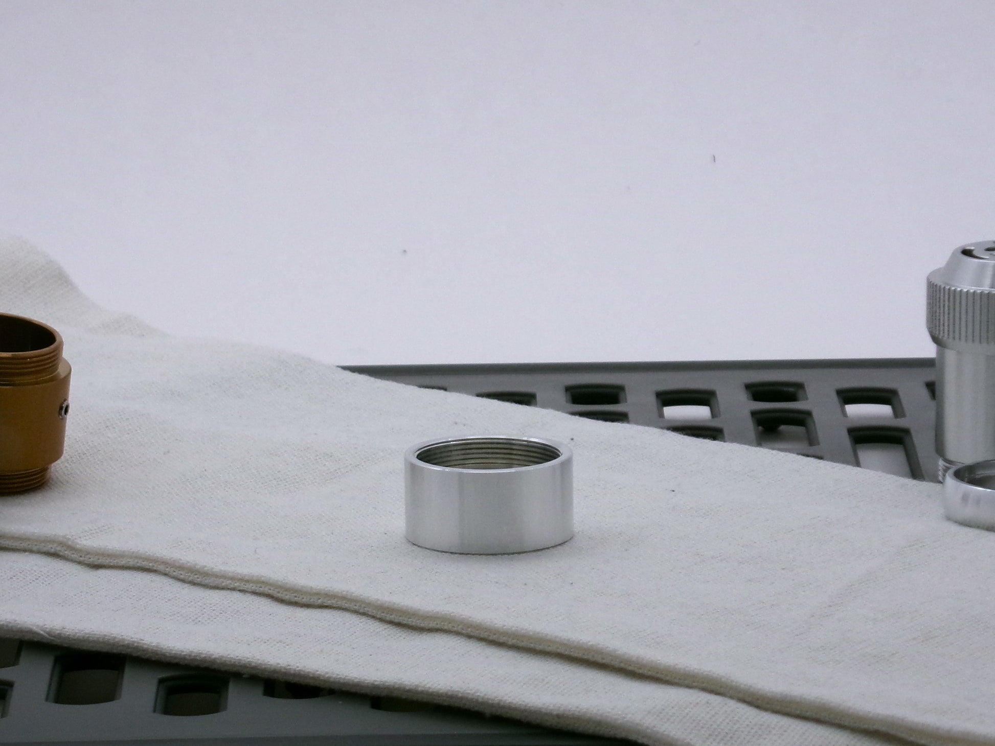 Single aluminum female/female threaded body component for VHC lightsabers; lying flat.