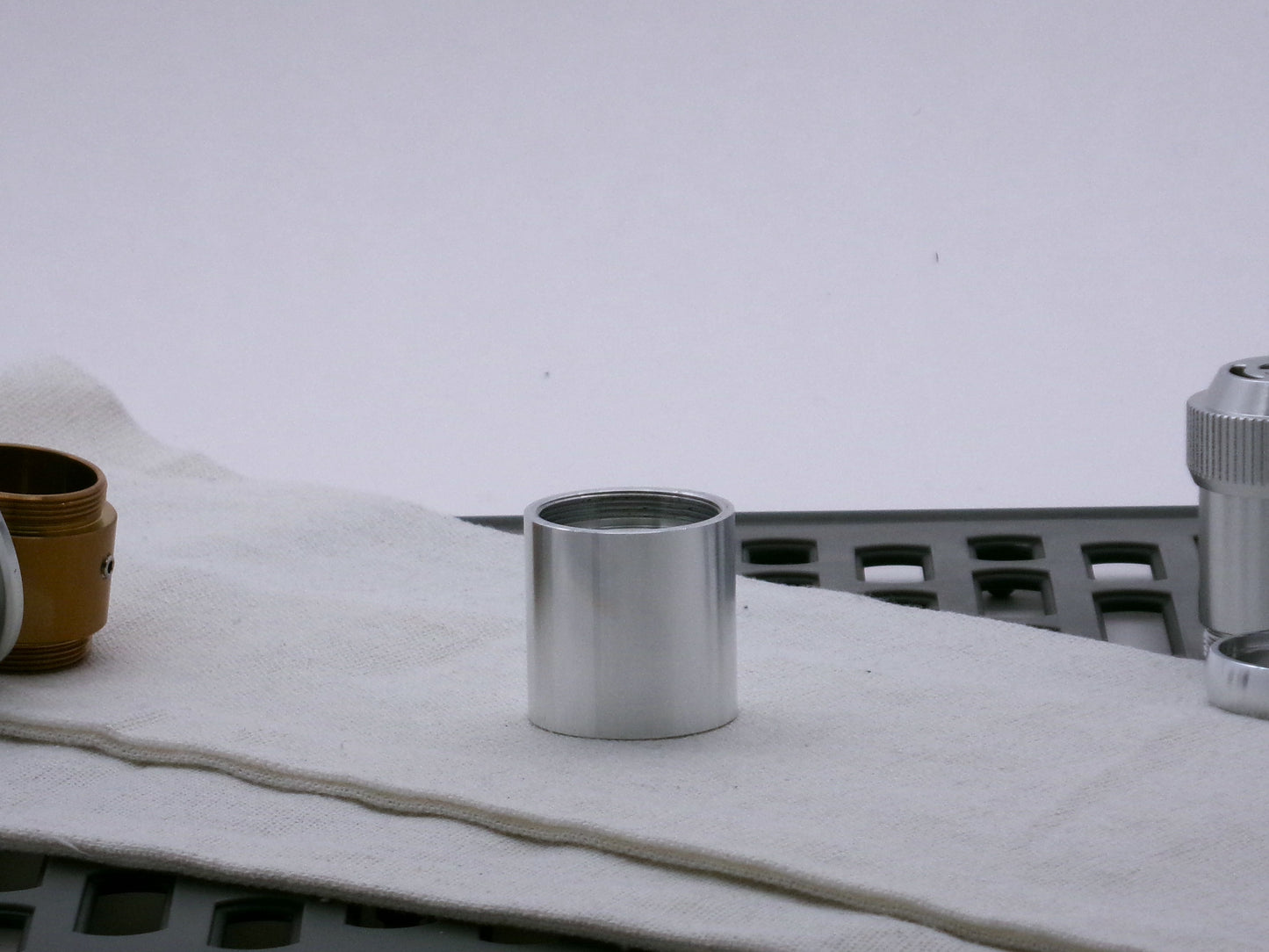 Single aluminum female/female threaded body component for VHC lightsabers; standing proud.