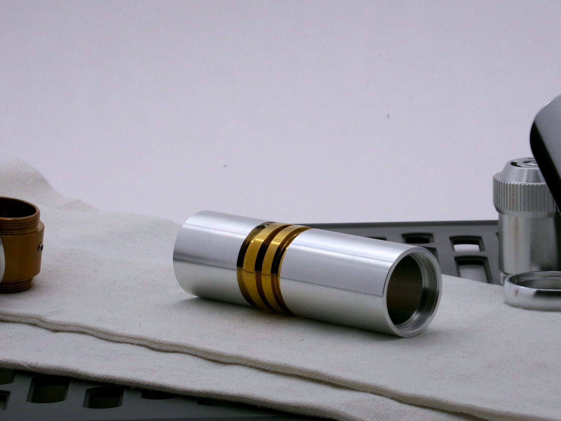 Single aluminum female/female threaded body component for VHC lightsabers; standing proud.