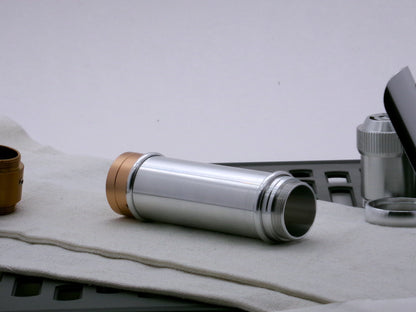 Single aluminum female/female threaded body component for VHC lightsabers combined with Accent rings and Adapters; three-quarter view.