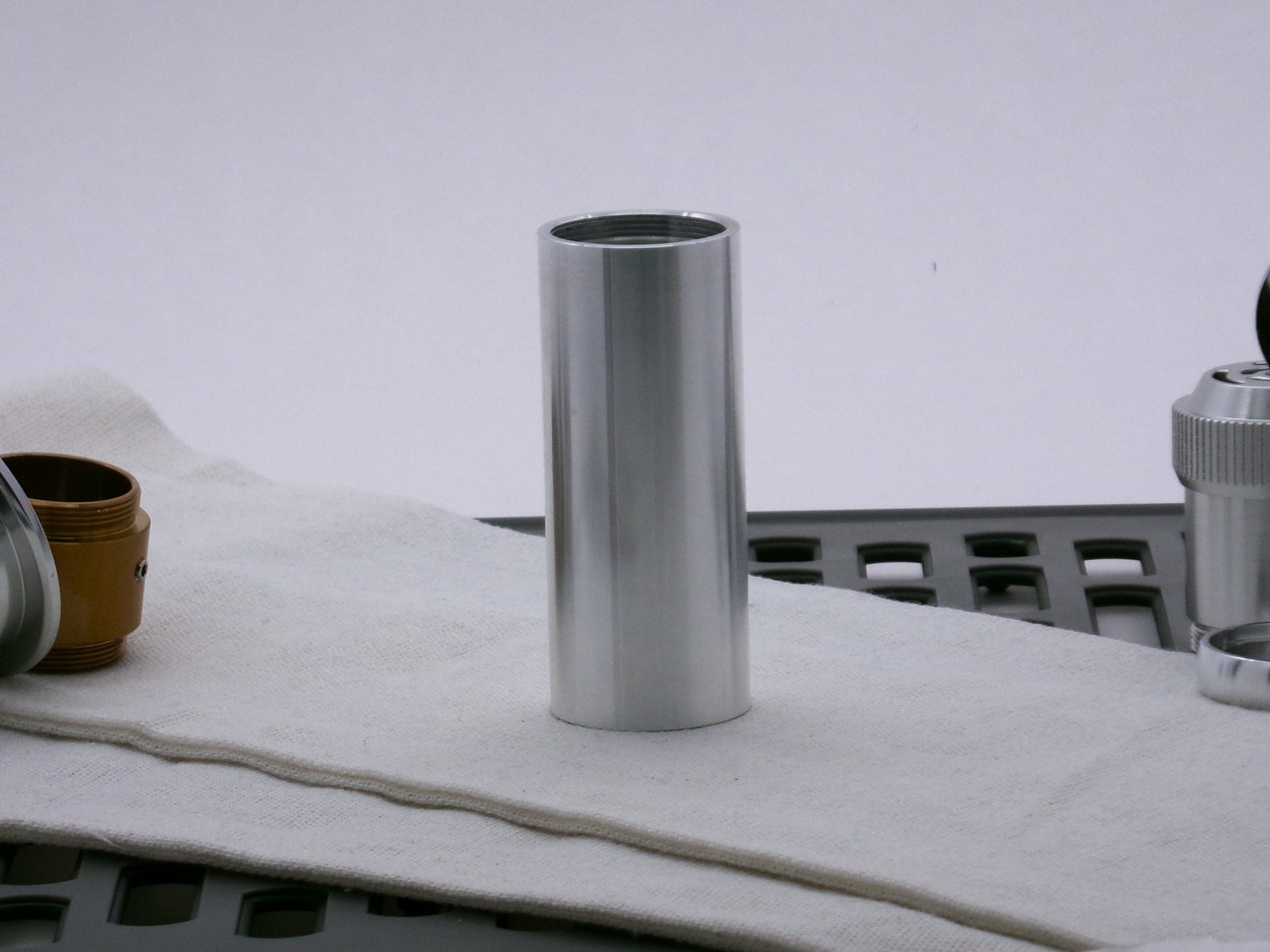 Single aluminum female/female threaded body component for VHC lightsabers; standing proud.