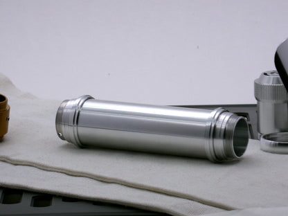 Single aluminum female/female threaded body component for VHC lightsabers combined with Accent rings and Adapters; three-quarter view.