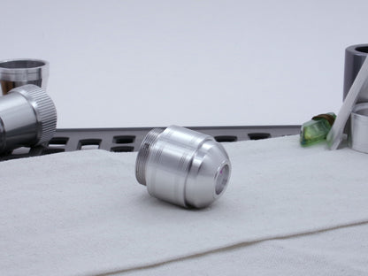 Assembled Pommel Assembly Kit for VHC lightsabers, sitting on cloth among lightsaber parts, three quarter view bottom .