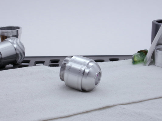 Assembled Pommel Assembly Kit for VHC lightsabers, sitting on cloth among lightsaber parts, three quarter view bottom .