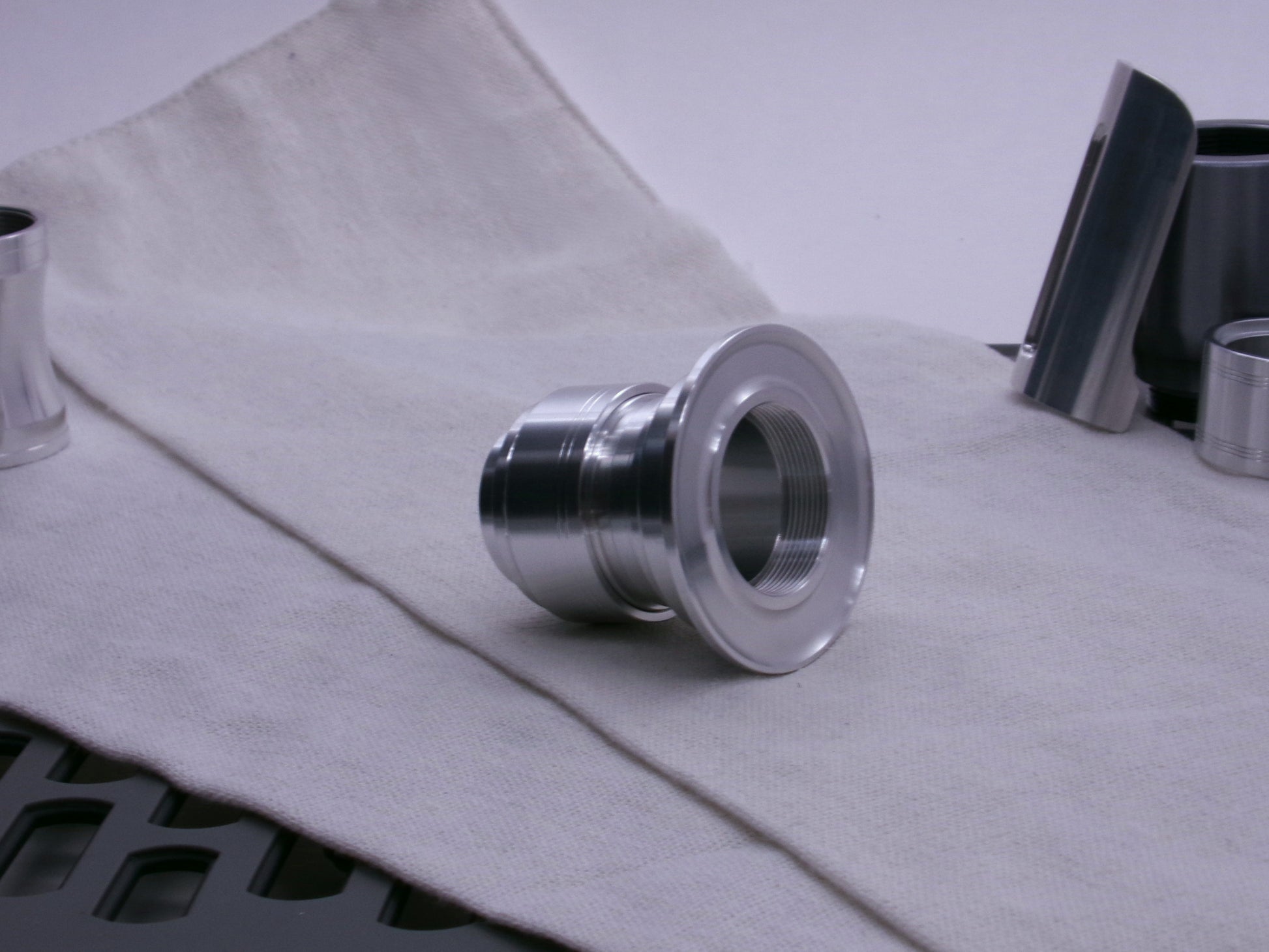 An aluminum emitter flange tops a composition of VHC compatible lightsaber components from Corvus Saber Foundry.